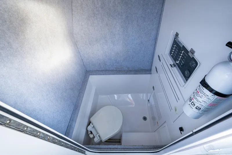 Slide: The Image of Compact marine bathroom in 2005 Jupiter 27 boat with toilet and fire extinguisher. - 30