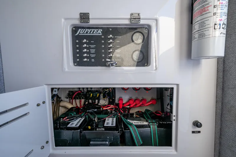 Slide: The Image of Electrical panel and battery compartment of a 2005 Jupiter 27 boat. - 31