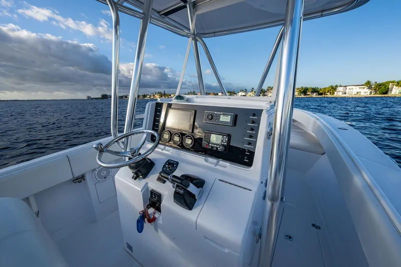 Slide: The Image of Center console of a 2005 Jupiter 27 boat on a sunny day, overlooking the water. - 35