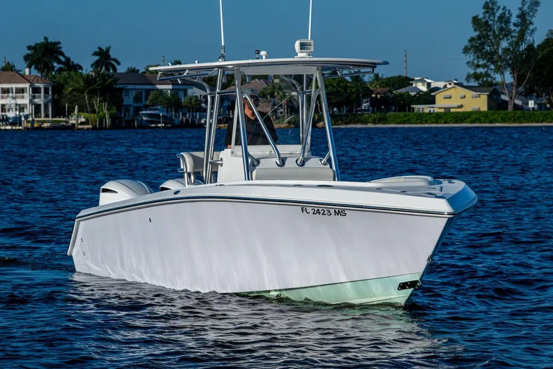 Slide: The Image of 2005 Jupiter 27 boat on calm water near residential shoreline. - 44