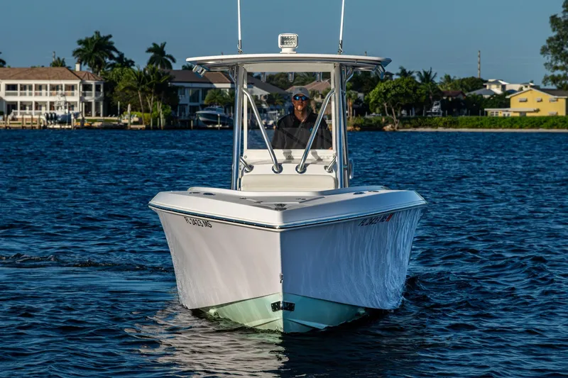 Slide: The Image of 2005 Jupiter 27 boat cruising on a sunny day near waterfront homes. - 45