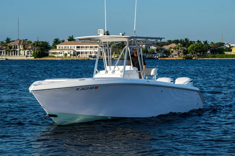 Slide: The Image of 2005 Jupiter 27 boat cruising on a sunny day near waterfront homes. - 46