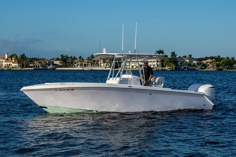 Slide: The Image of 2005 Jupiter 27 boat cruising on a sunny day near waterfront homes. - 47
