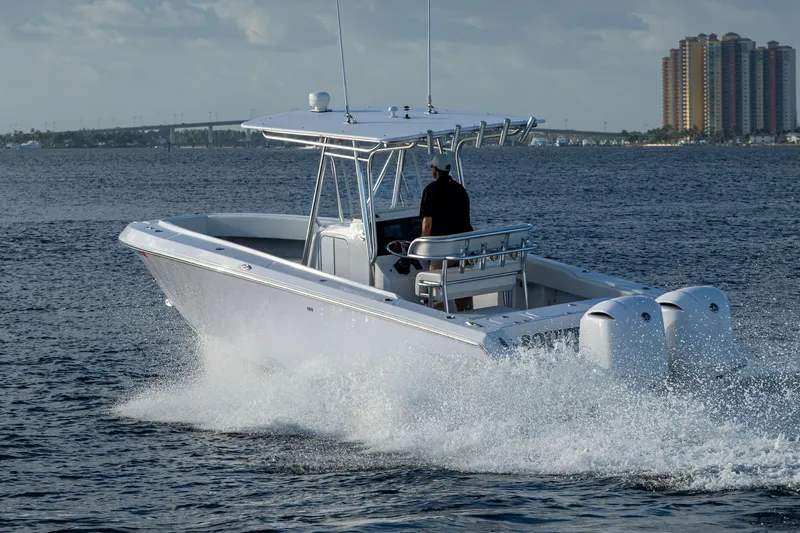 Slide: The Image of A 2005 Jupiter 27 boat cruising on the water with twin engines. - 51