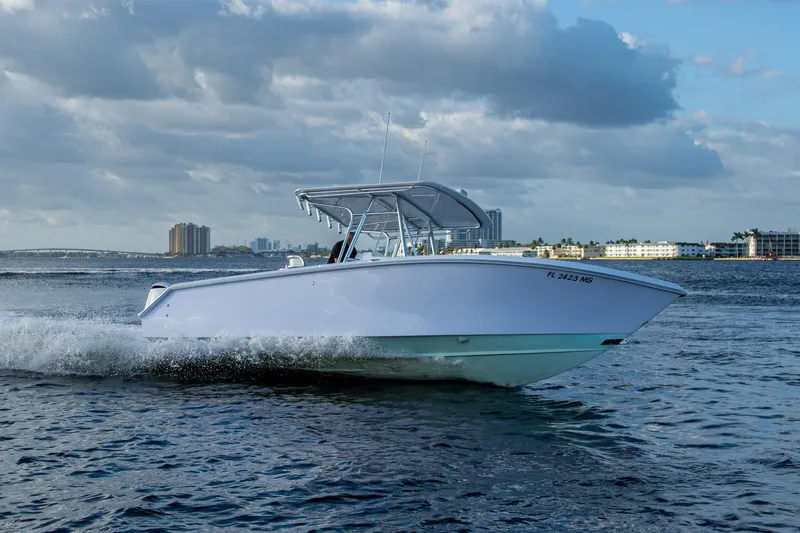 Slide: The Image of 2005 Jupiter 27 boat cruising on water under cloudy sky. - 54