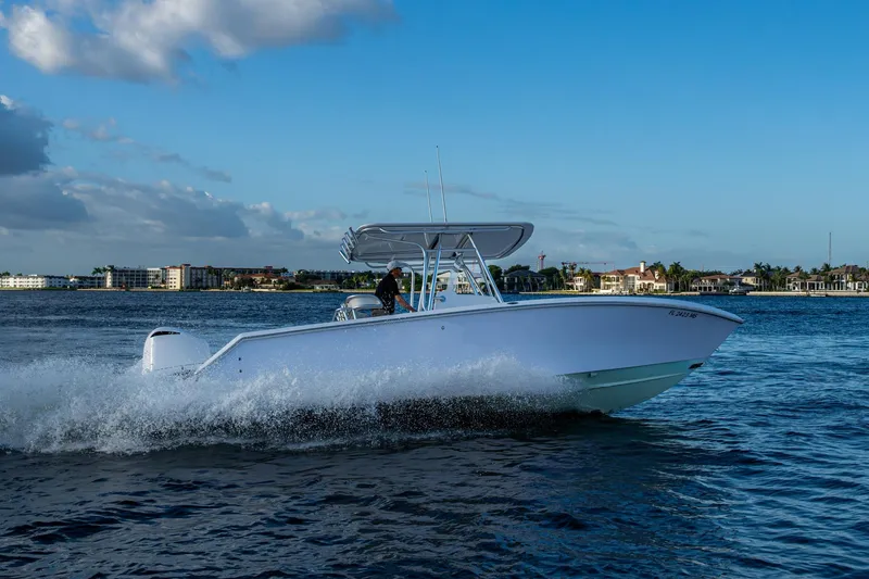 Slide: The Image of 2005 Jupiter 27 boat cruising on blue water under a clear sky. - 55