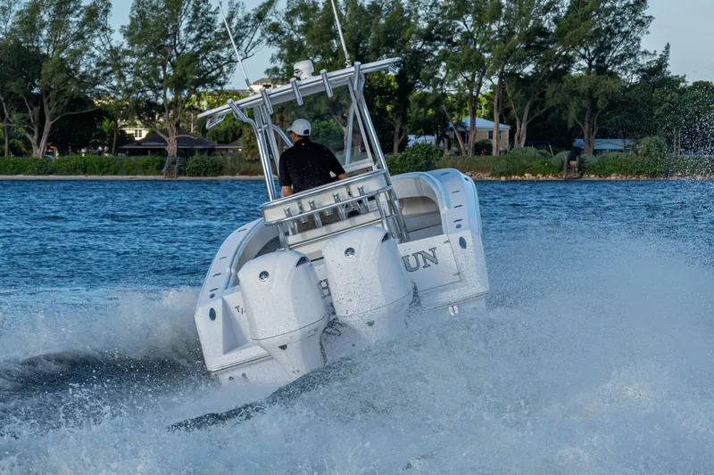 Slide: The Image of Boat speeding on water, Jupiter 27 model, 2005, with trees in the background. - 56
