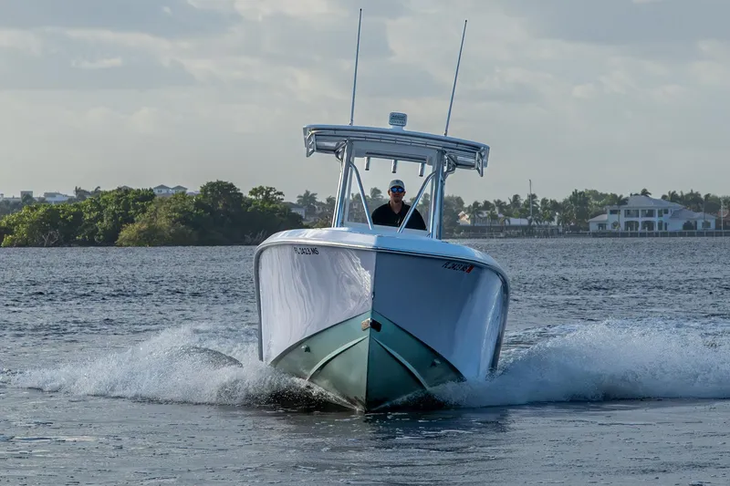 Slide: The Image of 2005 Jupiter 27 boat cruising on water with scenic background. - 60