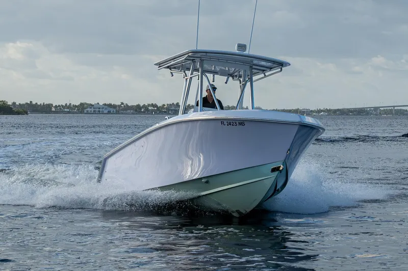 Slide: The Image of 2005 Jupiter 27 boat cruising on open water under cloudy skies. - 61