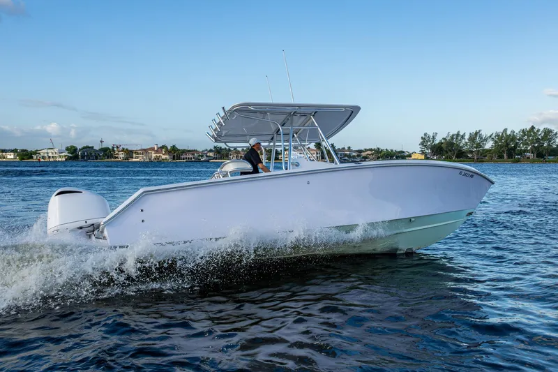 Slide: The Image of 2005 Jupiter 27 boat cruising on a sunny day, with a clear blue sky. - 62