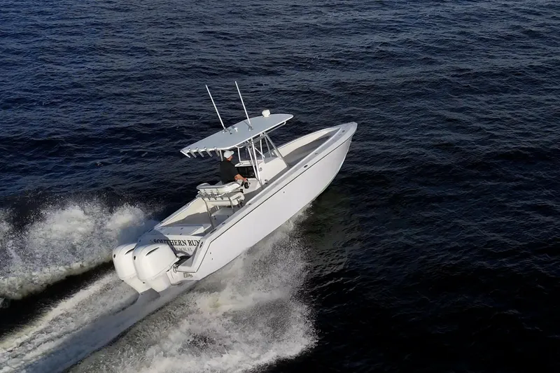 Slide: The Image of A 2005 Jupiter 27 boat cruising swiftly on open water. - 7