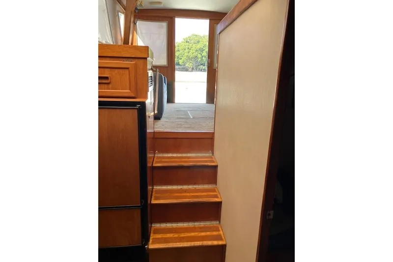 Slide: The Image of Interior stairs of 1979 Pacemaker 40 Sportfisher with wooden finish and natural light. - 12