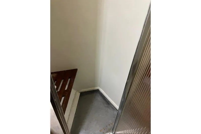 Slide: The Image of Interior corner of a 1979 Pacemaker 40 Sportfisher boat with wooden bench. - 19