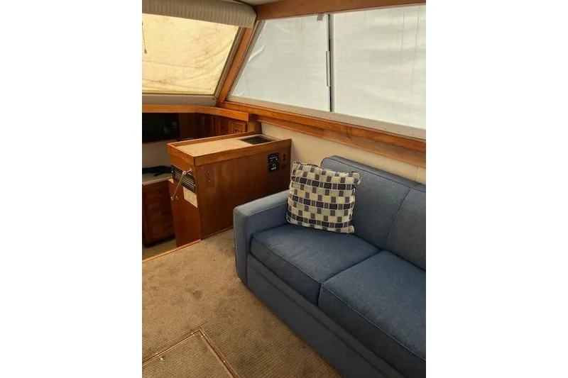 Slide: The Image of Interior of 1979 Pacemaker 40 Sportfisher with blue sofa and checkered pillow. - 2
