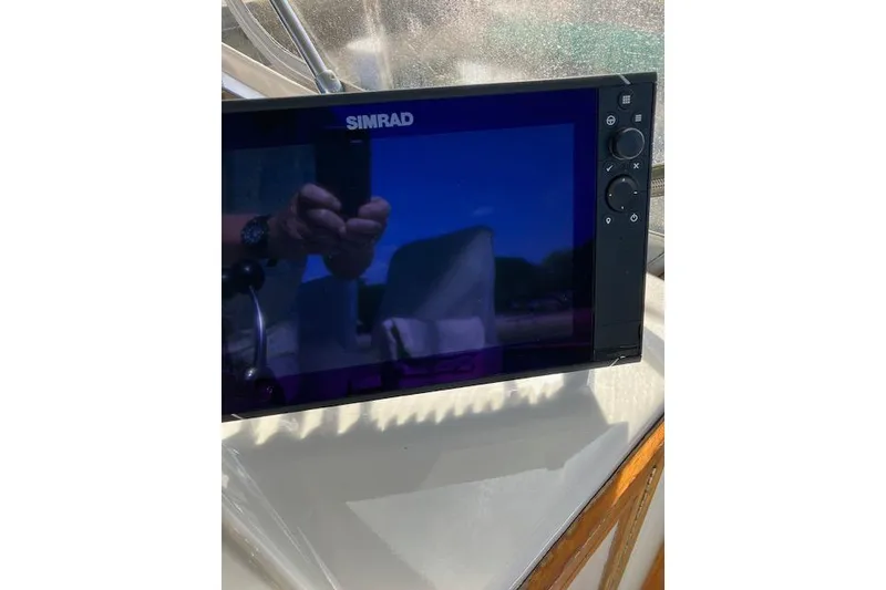 Slide: The Image of Simrad display on 1979 Pacemaker 40 Sportfisher boat, reflecting surroundings. - 29