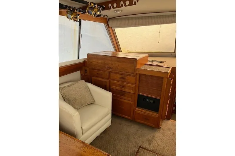Slide: The Image of Interior of 1979 Pacemaker 40 Sportfisher with wooden cabinetry and white armchair. - 3