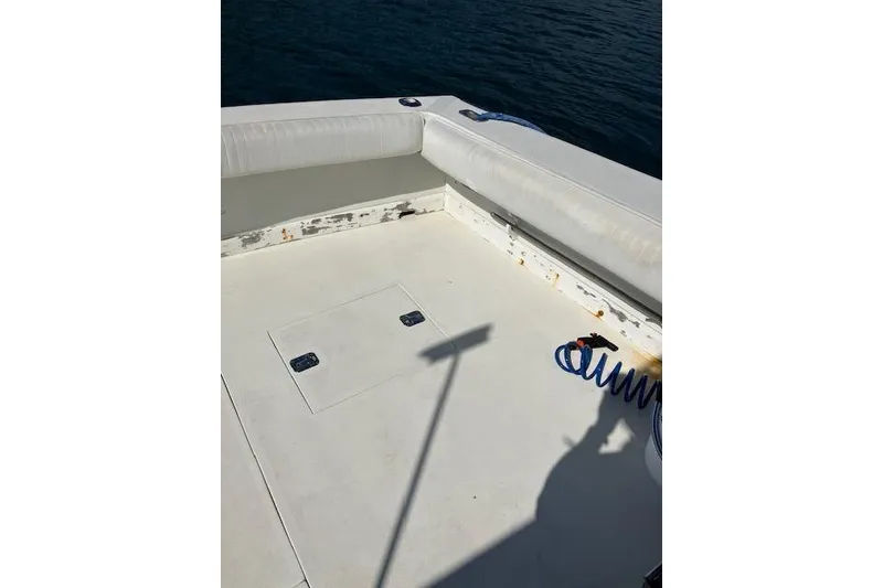 Slide: The Image of 1979 Pacemaker 40 Sportfisher boat deck with seating and coiled blue hose. - 34