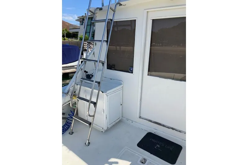 Slide: The Image of 1979 Pacemaker 40 Sportfisher boat deck with ladder and storage compartment. - 36