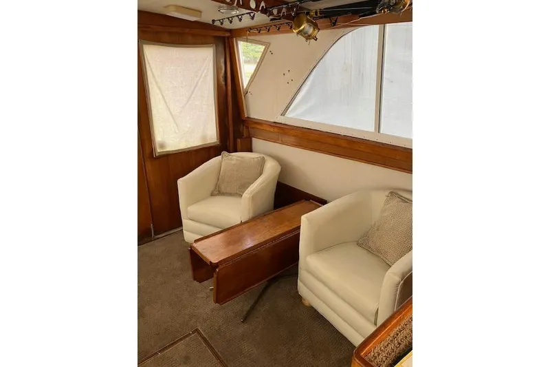 Slide: The Image of Interior of 1979 Pacemaker 40 Sportfisher with cozy seating and wooden accents. - 4