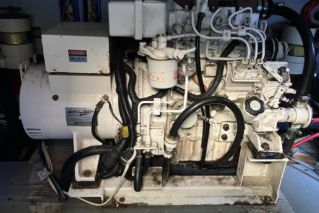 Slide: The Image of 1979 Pacemaker 40 Sportfisher engine, showcasing intricate mechanical components and wiring. - 42