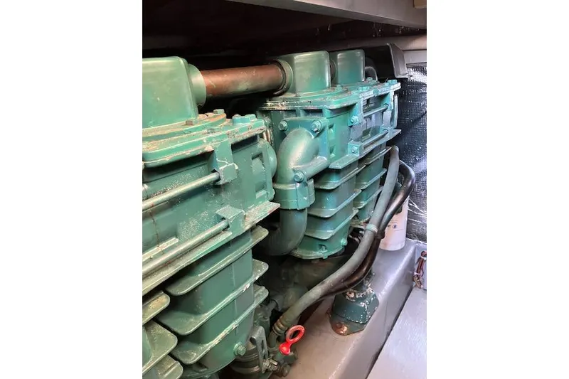 Slide: The Image of Engine compartment of a 1979 Pacemaker 40 Sportfisher boat, showcasing green machinery. - 44