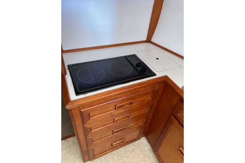 Slide: The Image of 1979 Pacemaker 40 Sportfisher kitchen with stove and wooden cabinetry. - 9