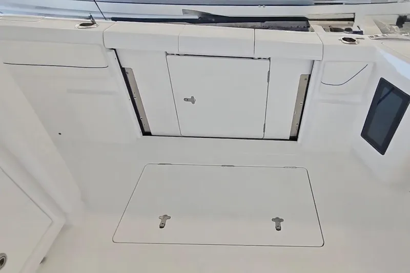 Slide: The Image of 2025 Intrepid 43 Nomad SE boat with luxurious seating and powerful outboard engines. - 12