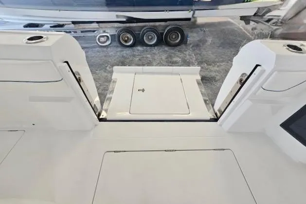 Slide: The Image of 2025 Intrepid 43 Nomad SE boat interior with sleek white design and modern fixtures. - 13