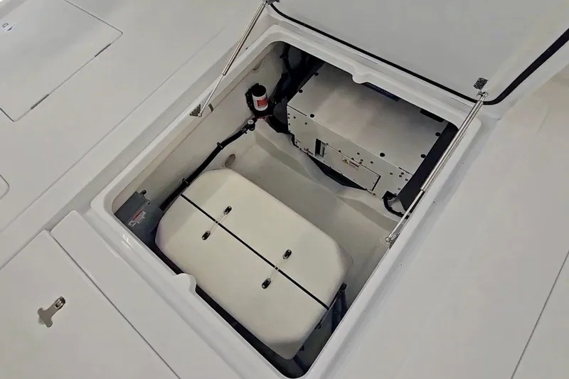 Slide: The Image of 2025 Intrepid 43 Nomad SE boat interior with open deck hatch and trailer in background. - 15