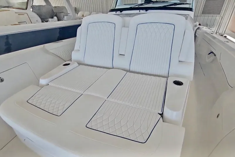 Slide: The Image of Luxurious seating area on 2025 Intrepid 43 Nomad SE boat, featuring elegant white upholstery. - 23