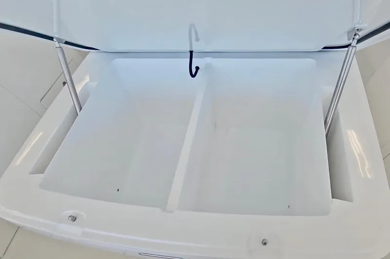 Slide: The Image of 2025 Intrepid 43 Nomad SE boat with luxurious white seating and cup holders. - 25