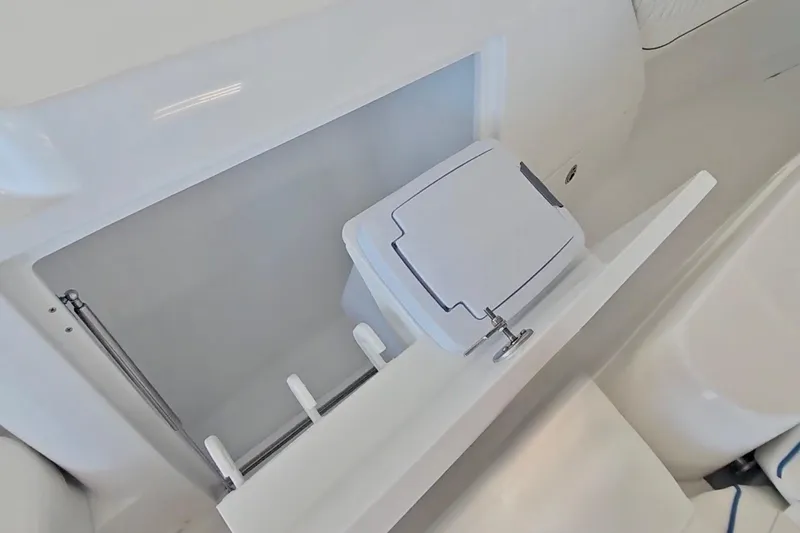 Slide: The Image of Open storage compartment on 2025 Intrepid 43 Nomad SE boat, featuring dual sections. - 27