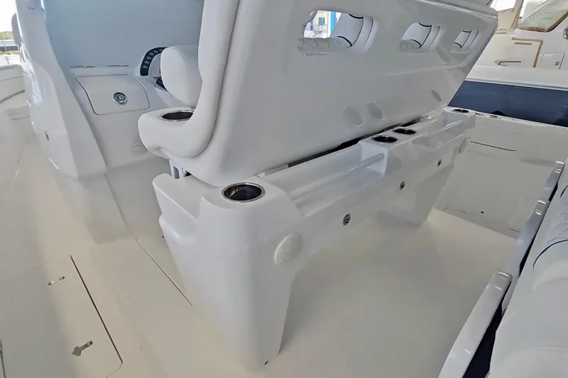 Slide: The Image of Luxurious seating on the 2025 Intrepid 43 Nomad SE boat, featuring white cushioned chairs. - 32