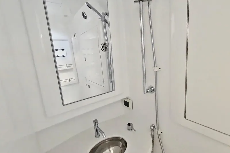 Slide: The Image of 2025 Intrepid 43 Nomad SE boat bathroom with toilet and shower area. - 44