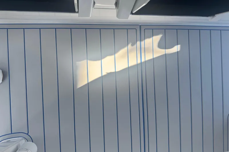 Slide: The Image of Interior of 2025 Intrepid 43 Nomad SE boat, featuring storage compartments and sleek design. - 49