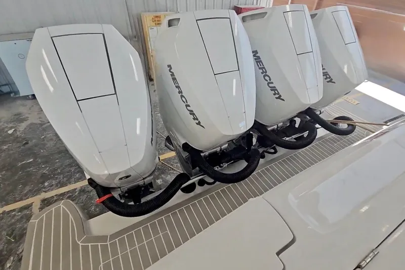 Slide: The Image of 2025 Intrepid 43 Nomad SE boat with four outboard engines docked in a marina. - 5