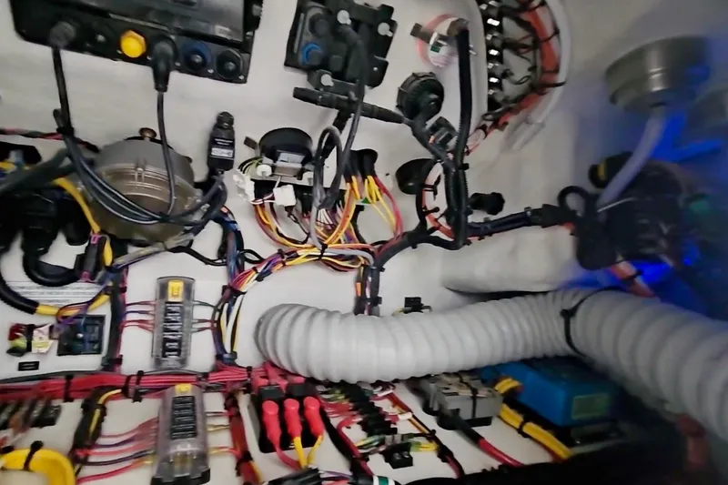 Slide: The Image of Electrical wiring system inside 2025 Intrepid 43 Nomad SE boat, showcasing complex cable arrangement. - 55