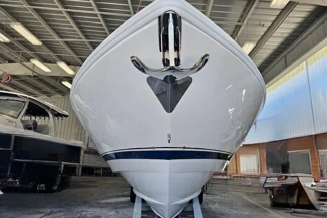 Slide: The Image of 2025 Intrepid 43 Nomad SE boat in a storage facility, front view. - 61