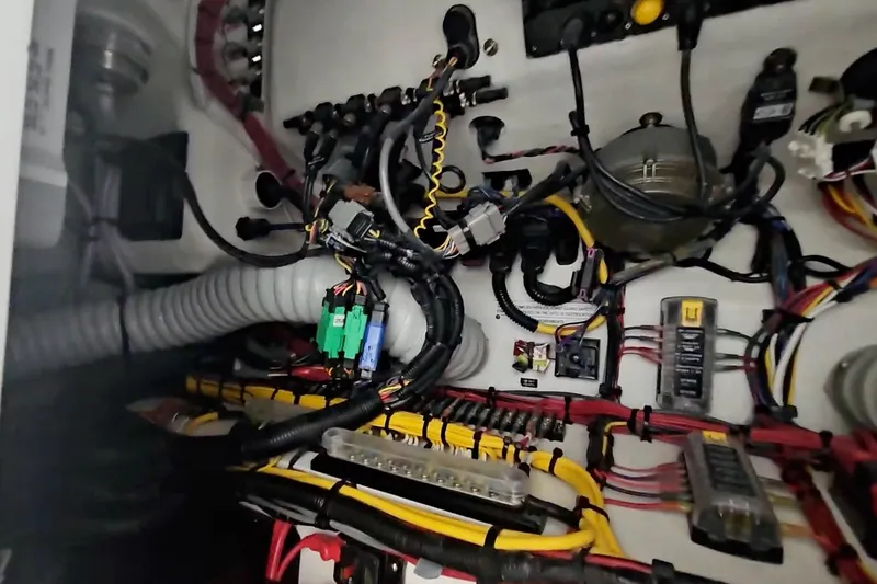 Slide: The Image of Electrical wiring system inside 2025 Intrepid 43 Nomad SE boat, showcasing complex cable arrangement. - 71