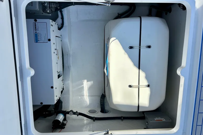 Slide: The Image of Engine compartment of 2025 Intrepid 43 Nomad SE boat, showcasing equipment and storage. - 74