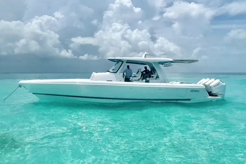 Slide: The Image of 2025 Intrepid 43 Nomad SE boat on clear turquoise water. - 79