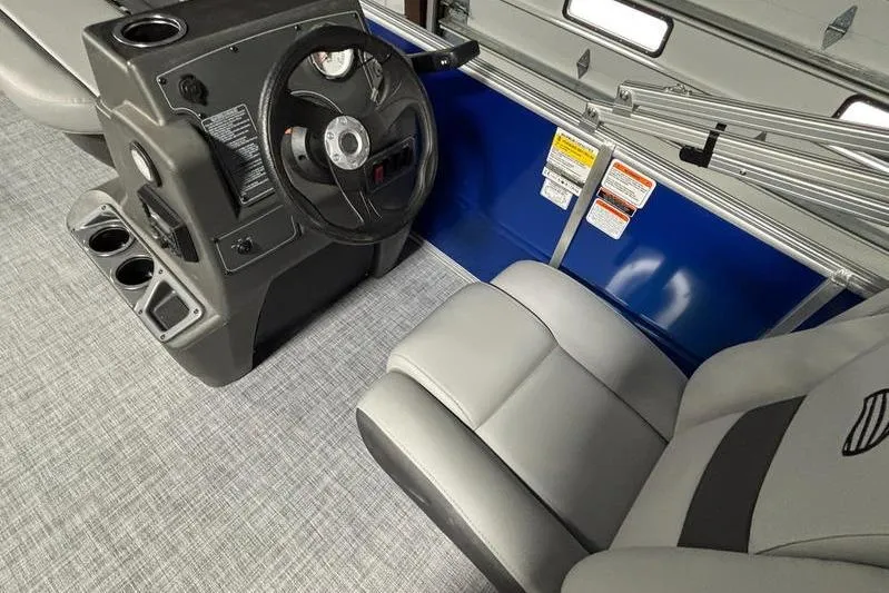 Slide: The Image of 2026 Sun Tracker Party Barge 16 DLX interior with steering console and seating. - 11