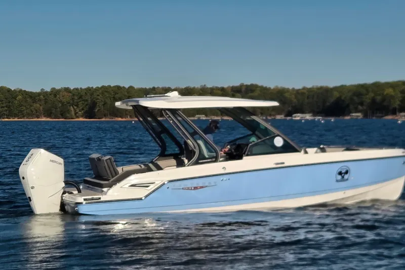 Slide: The Image of Interior of 2026 Monterey Elite 27 OB boat with modern dashboard and seating. - 11