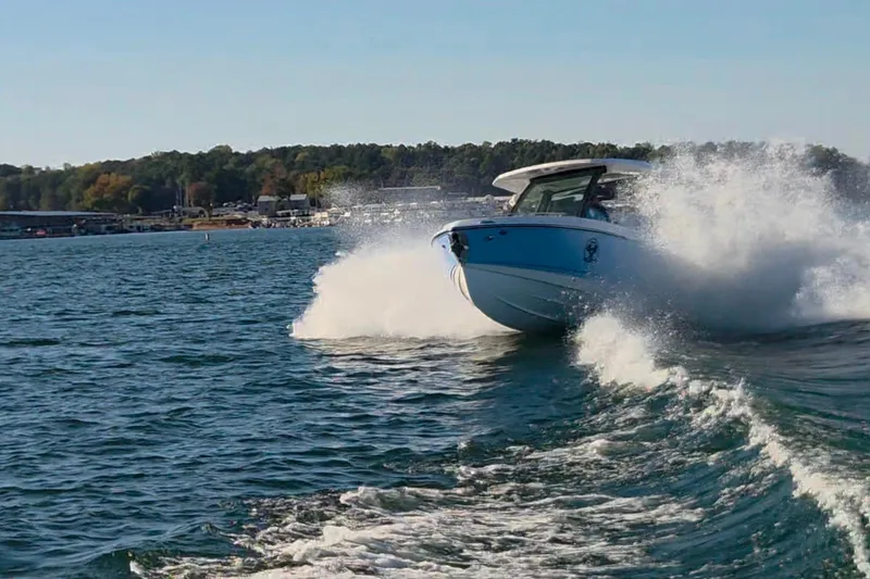 Slide: The Image of 2026 Monterey Elite 27 OB boat cruising on a lake, creating splashes. - 7