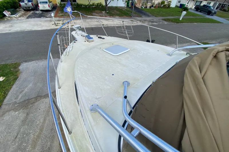 Slide: The Image of 2002 Wellcraft 290 Coastal boat deck view, parked in a residential driveway. - 20
