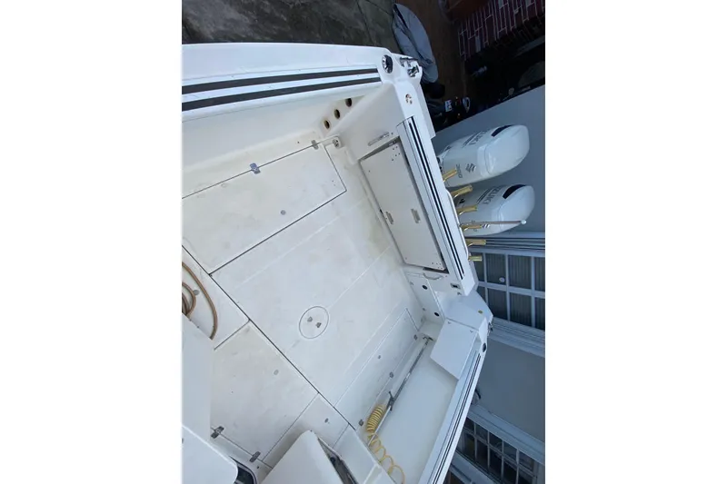 Slide: The Image of 2002 Wellcraft 290 Coastal boat deck with dual outboard engines. - 22