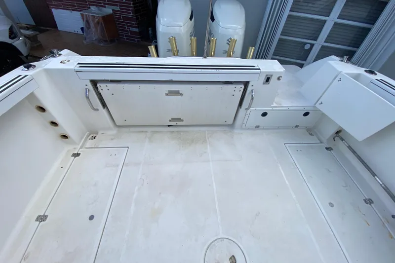 Slide: The Image of 2002 Wellcraft 290 Coastal boat deck with storage compartments and fishing rod holders. - 24