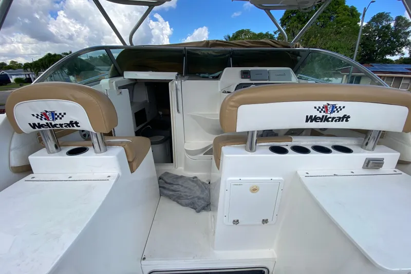 Slide: The Image of 2002 Wellcraft 290 Coastal boat interior with seating and dashboard view. - 25