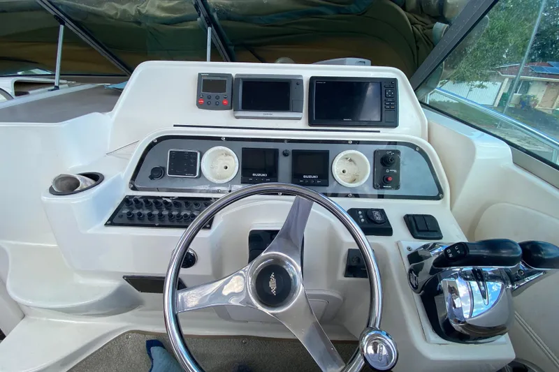 Slide: The Image of 2002 Wellcraft 290 Coastal helm with steering wheel, controls, and navigation displays. - 26