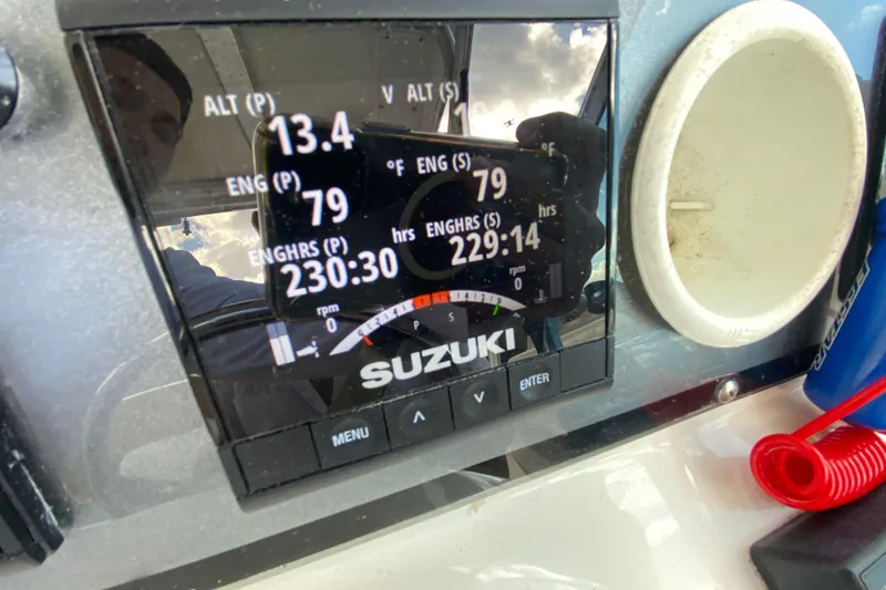 Slide: The Image of Suzuki engine display on 2002 Wellcraft 290 Coastal boat dashboard, showing engine hours and RPM. - 29